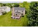 Aerial view of backyard featuring a comfortable deck, lush lawn and a home perfect for outdoor living at 12490 Windbush Way, Carmel, IN 46033