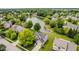 Aerial view of home showcasing lush greenery, neighborhood lake and manicured lawn for serene outdoor living at 12490 Windbush Way, Carmel, IN 46033