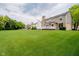 Spacious backyard features a well-manicured lawn and a home with a comfortable deck for outdoor relaxation at 12490 Windbush Way, Carmel, IN 46033