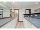 Basement bar with granite countertop, white cabinets, and a sink at 12490 Windbush Way, Carmel, IN 46033