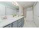 Bathroom features a double vanity, marble floors, a shower with a white curtain, and a white toilet at 12490 Windbush Way, Carmel, IN 46033