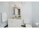 Bathroom with white vanity and granite top, new floors and a modern mirror at 12490 Windbush Way, Carmel, IN 46033