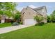 Beautiful brick home with an attached two car garage and green lawn at 12490 Windbush Way, Carmel, IN 46033