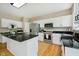 Well-lit kitchen with white cabinetry, a center island, and modern appliances at 12490 Windbush Way, Carmel, IN 46033