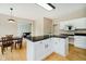 Charming kitchen with white cabinets, dark counters, and an adjacent dining area at 12490 Windbush Way, Carmel, IN 46033