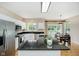 Spacious kitchen with white cabinets, stainless steel appliances, and a dark countertop island at 12490 Windbush Way, Carmel, IN 46033
