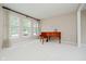 Bright living room with large windows and a grand piano at 12490 Windbush Way, Carmel, IN 46033