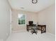 Bright office space with neutral walls, a desk, a chair, and a window view at 12490 Windbush Way, Carmel, IN 46033