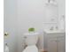 Cozy powder room features a gray vanity, a white toilet, and a round mirror at 12490 Windbush Way, Carmel, IN 46033
