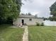 Exterior of the home's back with a small concrete patio and lawn chairs at 1395 Evans Ave, Noblesville, IN 46060