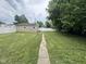 Backyard featuring a level yard with a walkway to the detached garage at 1395 Evans Ave, Noblesville, IN 46060
