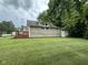 Spacious backyard featuring lush green grass and plenty of shade from mature trees at 1395 Evans Ave, Noblesville, IN 46060