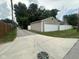 Long concrete driveway leading to the detached garage and backyard at 1395 Evans Ave, Noblesville, IN 46060