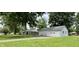 View of the backyard with an oversized two car garage and the home at 1400 Evelyn Ln, Anderson, IN 46017