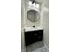 Stylish powder room with a round mirror, modern vanity, and decorative tile floors at 1400 Evelyn Ln, Anderson, IN 46017
