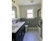 Updated bathroom features a double sink vanity, and stylish tile floors at 1400 Evelyn Ln, Anderson, IN 46017