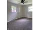 A bedroom with neutral walls, carpeted flooring, and a ceiling fan at 1400 Evelyn Ln, Anderson, IN 46017
