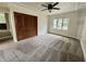 Carpeted bedroom featuring a ceiling fan, closet, and plenty of natural light at 1400 Evelyn Ln, Anderson, IN 46017