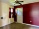 A bedroom with neutral and maroon walls and carpeted flooring at 1400 Evelyn Ln, Anderson, IN 46017
