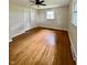 Bedroom featuring hardwood floors, a ceiling fan, and natural light at 1400 Evelyn Ln, Anderson, IN 46017