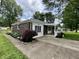Charming brick home with a covered front porch, nicely landscaped yard and concrete driveway at 1400 Evelyn Ln, Anderson, IN 46017