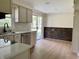 Eat-in kitchen with stainless steel appliances, white cabinets, and sliding door to the backyard at 1400 Evelyn Ln, Anderson, IN 46017