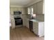 Updated kitchen featuring stainless steel appliances, white cabinets, and subway tile backsplash at 1400 Evelyn Ln, Anderson, IN 46017