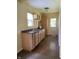 A kitchenette with wooden cabinets, laminate floors, and sink at 1400 Evelyn Ln, Anderson, IN 46017