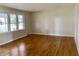 Bright living room featuring gleaming hardwood floors and a large picture window at 1400 Evelyn Ln, Anderson, IN 46017