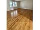 Spacious living room featuring gleaming hardwood floors and natural light at 1400 Evelyn Ln, Anderson, IN 46017