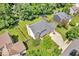 Aerial view of home with a manicured lawn, mature trees, fenced backyard, and a spacious driveway at 15075 Windsor Ln, Noblesville, IN 46060