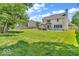 Spacious backyard with lush green grass, patio area, and a charming pergola, perfect for outdoor relaxation at 15075 Windsor Ln, Noblesville, IN 46060