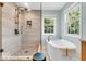 Elegant bathroom with a glass shower, soaking tub, and natural light at 15075 Windsor Ln, Noblesville, IN 46060