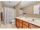 Bathroom featuring a double vanity with a wooden cabinet and a shower-tub combination with a decorative shower curtain at 15075 Windsor Ln, Noblesville, IN 46060