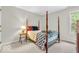 Inviting bedroom with a four-poster bed, showcasing a traditional design and a comforting atmosphere at 15075 Windsor Ln, Noblesville, IN 46060