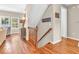 Welcoming foyer features hardwood floors, staircase, and decor; natural light streams through nearby windows at 15075 Windsor Ln, Noblesville, IN 46060