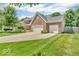 Charming brick home with a well-manicured lawn, mature trees, and a two-car garage at 15075 Windsor Ln, Noblesville, IN 46060