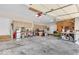 Spacious three-car garage with ample storage space and a door to the exterior at 15075 Windsor Ln, Noblesville, IN 46060