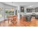 Modern kitchen with grey cabinets, and a dining area with hardwood floors, and backyard access at 15075 Windsor Ln, Noblesville, IN 46060
