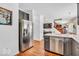 Spacious kitchen with stainless steel refrigerator, granite countertops, and an island at 15075 Windsor Ln, Noblesville, IN 46060