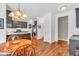 Charming eat-in kitchen with dark cabinets, stainless appliances, and a decorative light fixture above the table at 15075 Windsor Ln, Noblesville, IN 46060