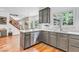 Bright kitchen with stainless steel appliances, modern light fixtures, and hardwood floors at 15075 Windsor Ln, Noblesville, IN 46060