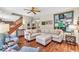 Comfortable living room featuring hardwood floors, staircase and ample seating at 15075 Windsor Ln, Noblesville, IN 46060