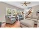 Bright living room with hardwood floors, large windows, and comfortable seating arrangement at 15075 Windsor Ln, Noblesville, IN 46060