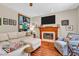 Cozy living room featuring a fireplace, and a TV, perfect for relaxation and entertainment at 15075 Windsor Ln, Noblesville, IN 46060