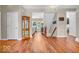 Hardwood floors lead to the living room, adjoining the staircase and a display cabinet at 15075 Windsor Ln, Noblesville, IN 46060