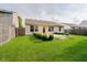 The spacious backyard includes a grassy lawn, trimmed shrubs, and a patio area for outdoor enjoyment at 16629 Greensboro Dr, Westfield, IN 46074