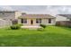 This backyard offers a well-maintained lawn, patio, trimmed shrubs, and fencing for privacy at 16629 Greensboro Dr, Westfield, IN 46074