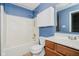 The bathroom includes a shower-tub, white cabinets, and a wood-style vanity and flooring at 16629 Greensboro Dr, Westfield, IN 46074