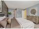 This primary bedroom features a wood accent wall, modern décor, and bright natural lighting at 16629 Greensboro Dr, Westfield, IN 46074